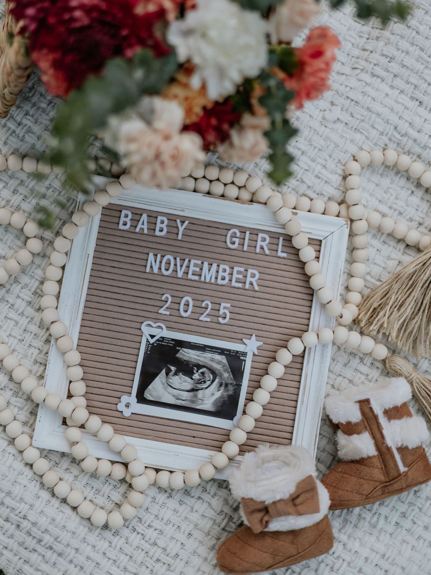 Baby girl pregnancy announcement letter board with ultrasound photo for November 2025.