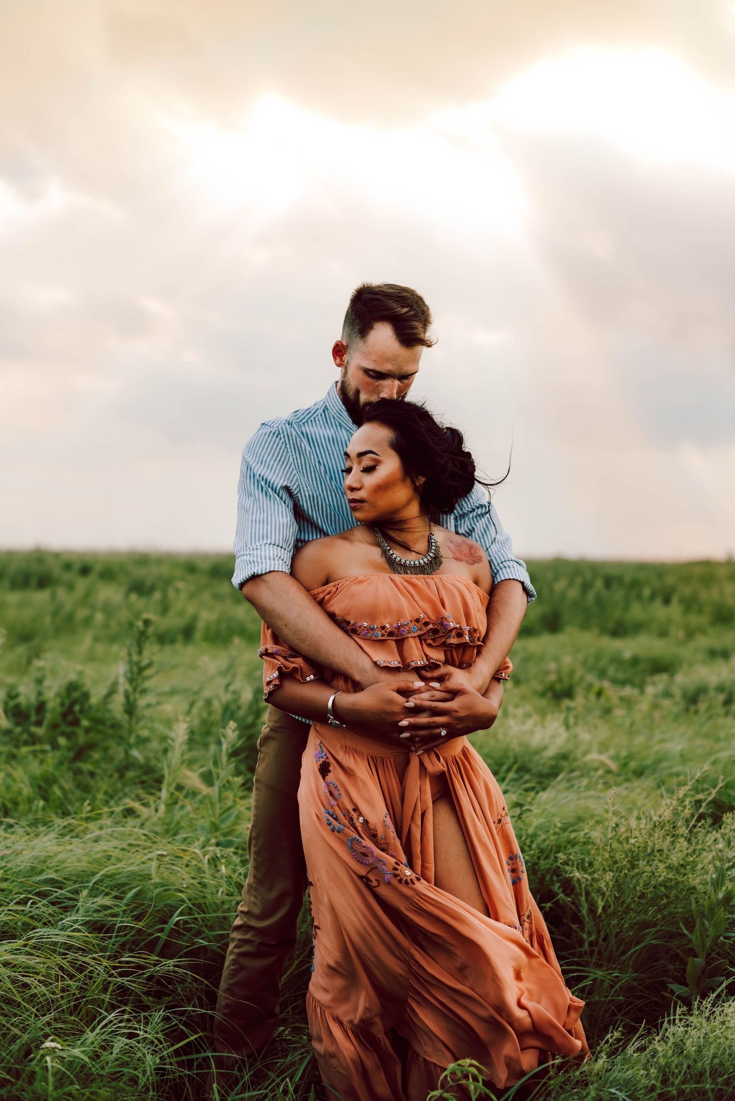 a man embracing a woman in a field