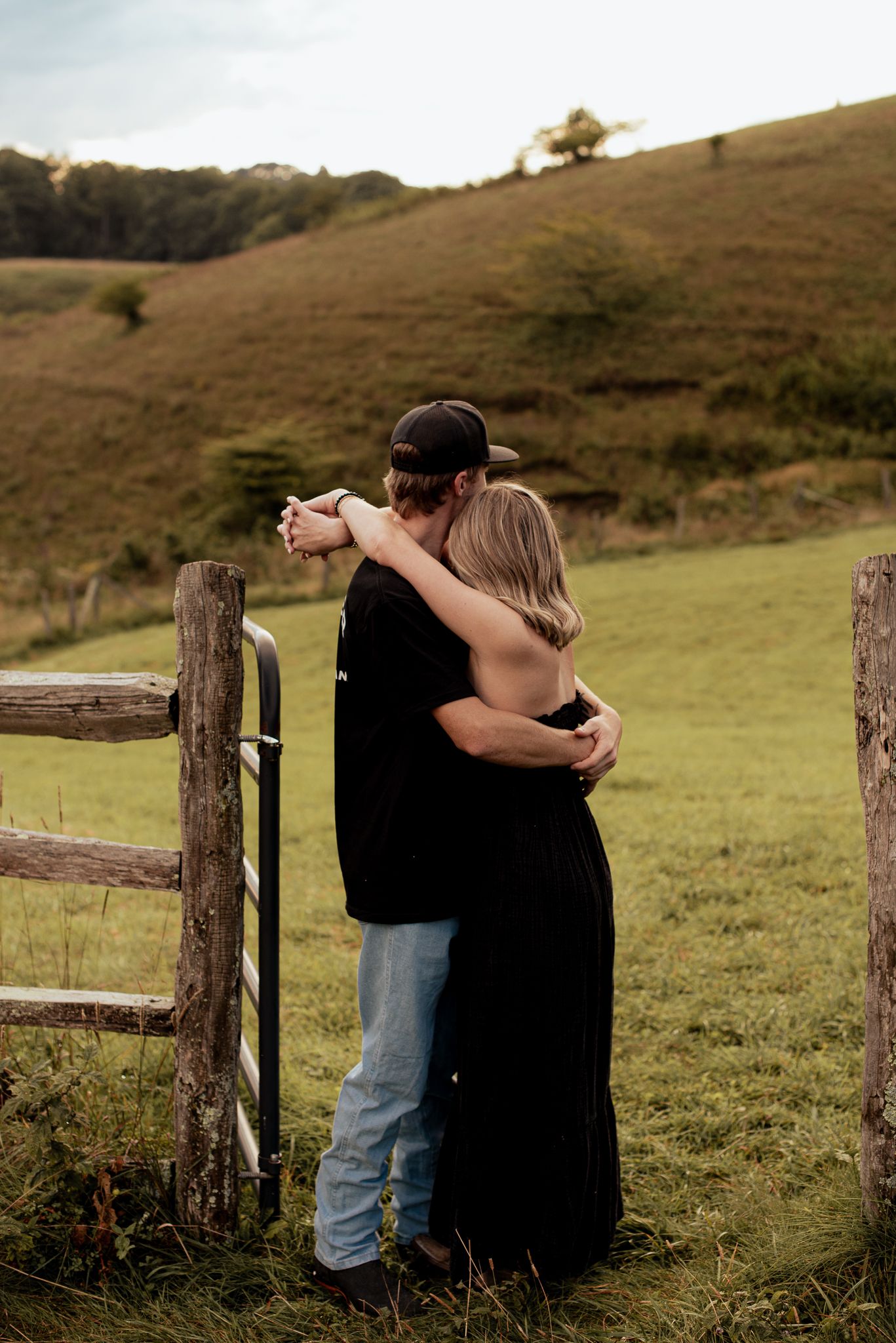 a couple from behind ,staring off into the distance