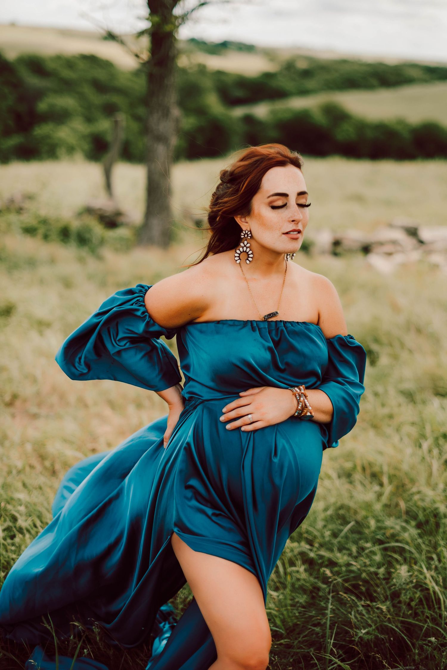 a pregnant woman with a blue flowing dress
