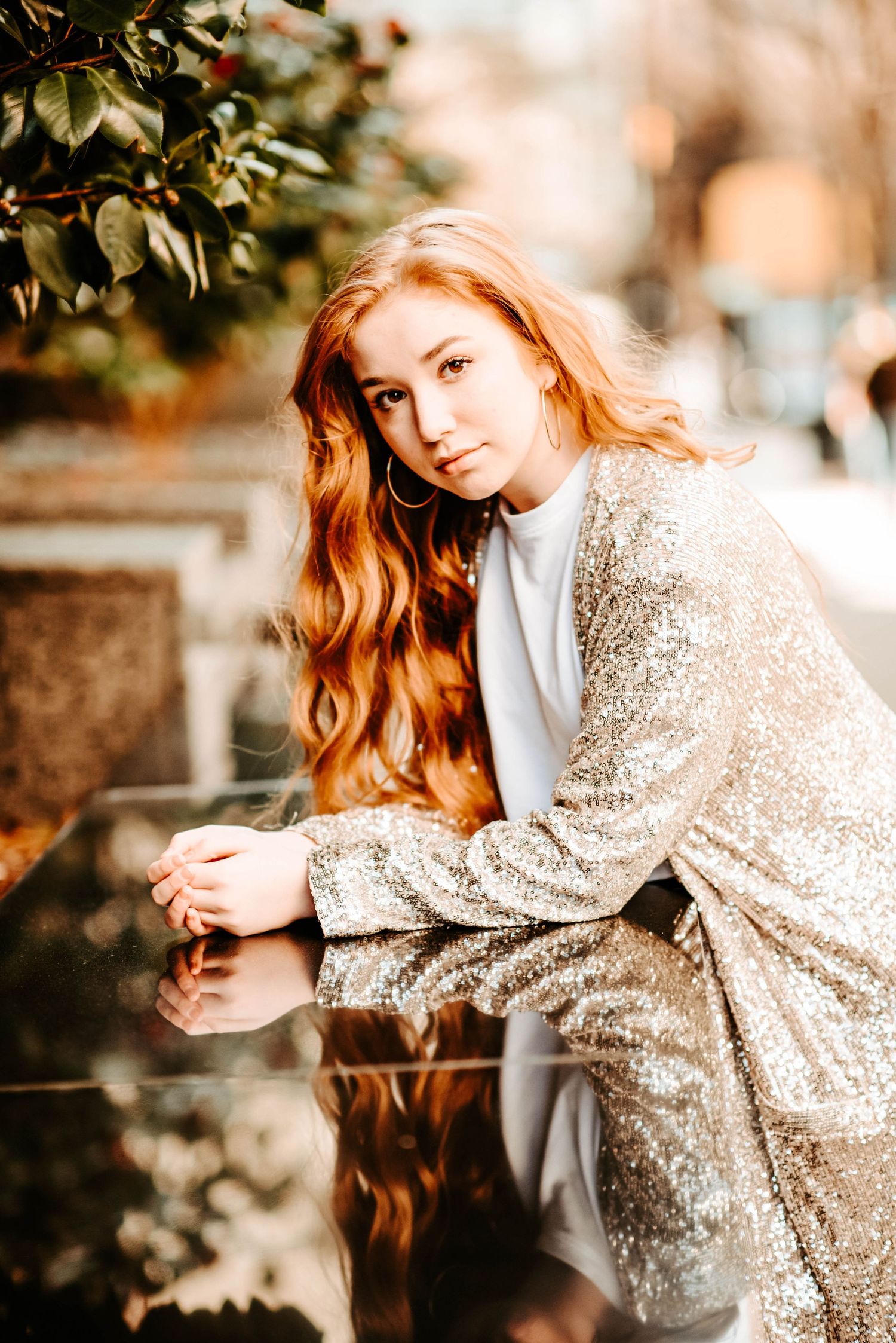 a girl leaning on a marble wall with reflection