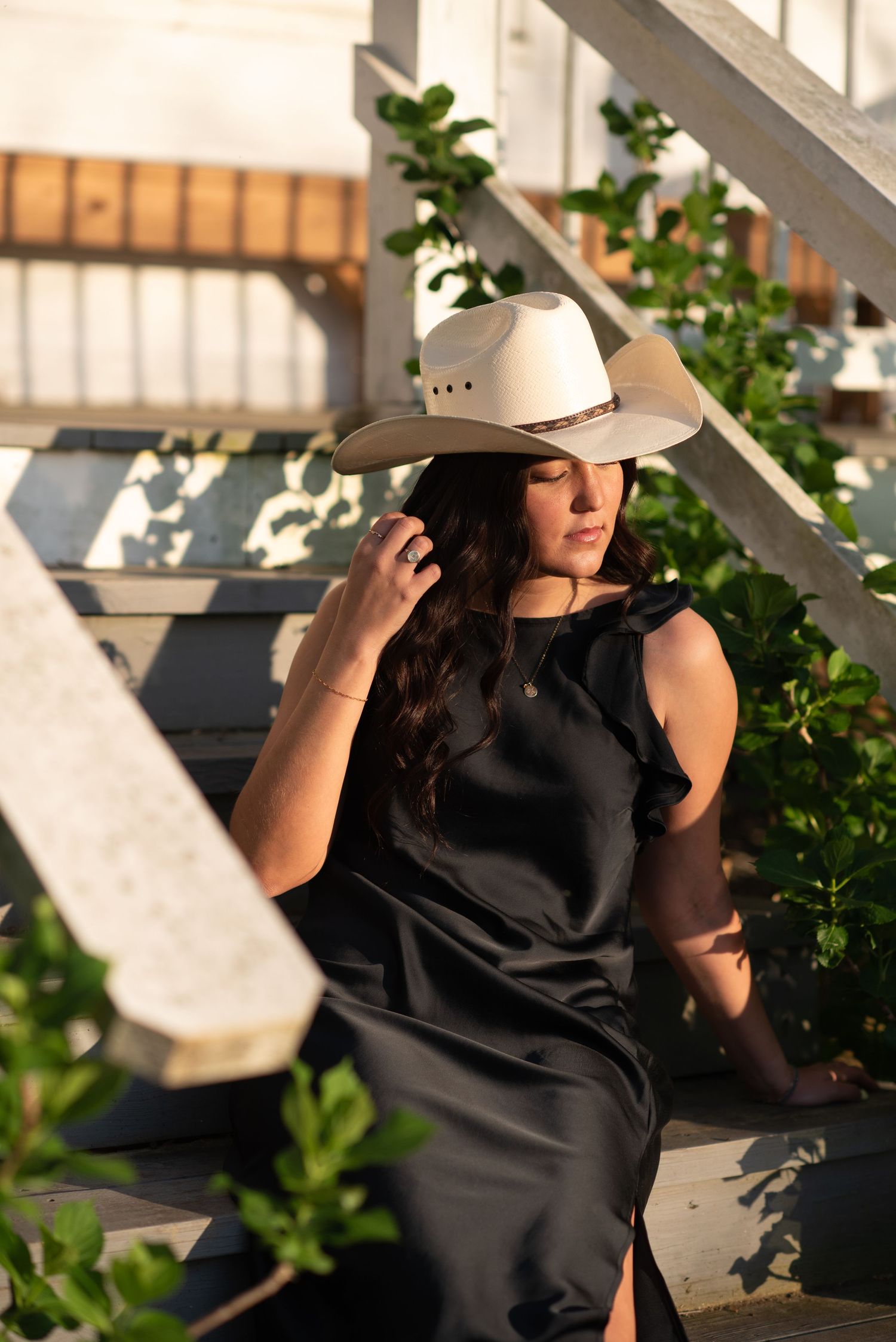 A girl in a cowgirl hat drenched in golden light