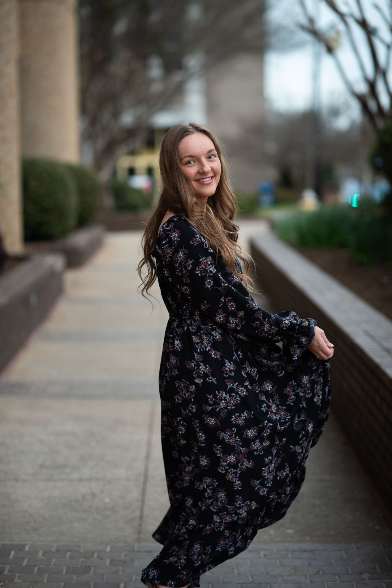 A girl in a dark dress twirling