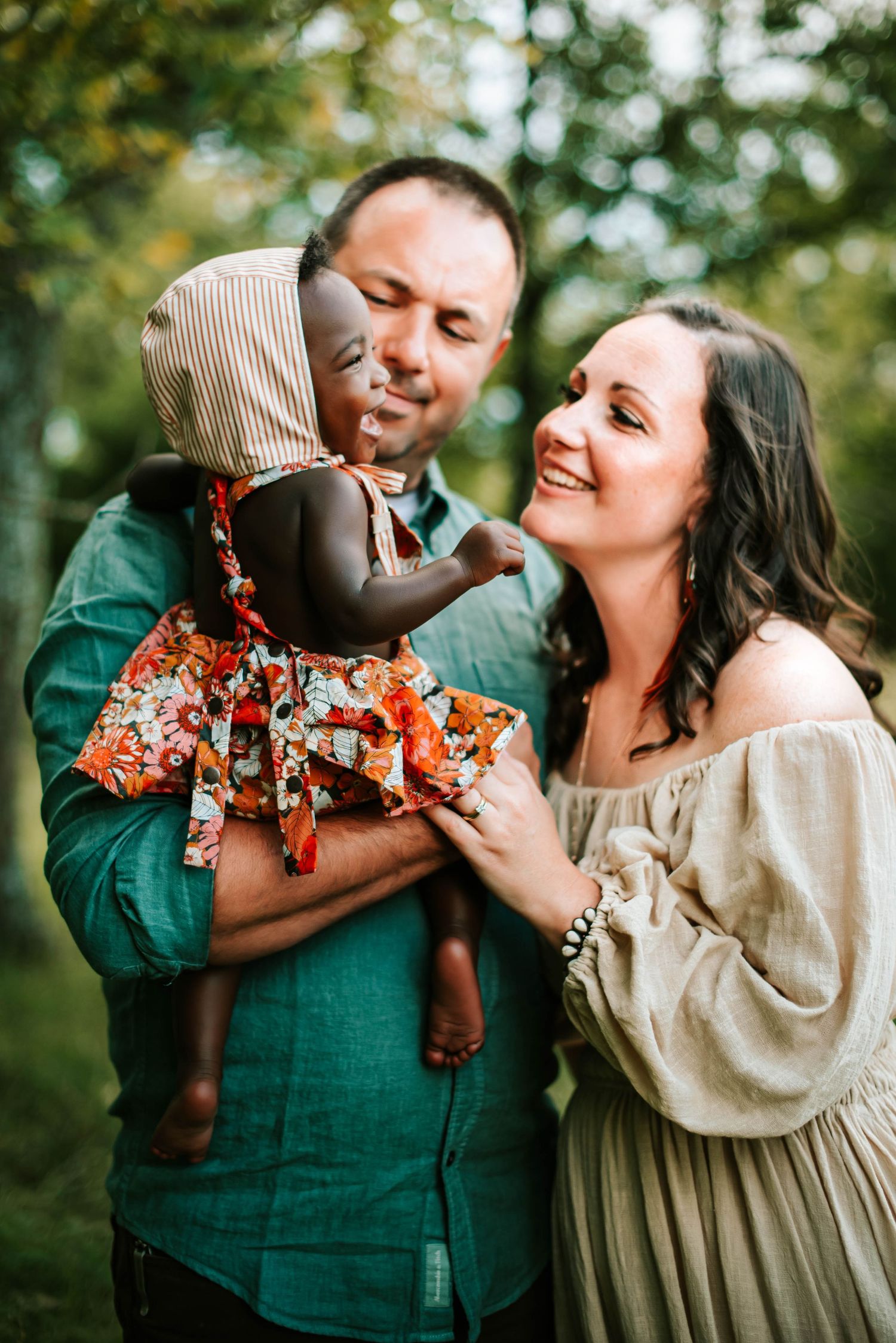 a mom and dad holding their baby