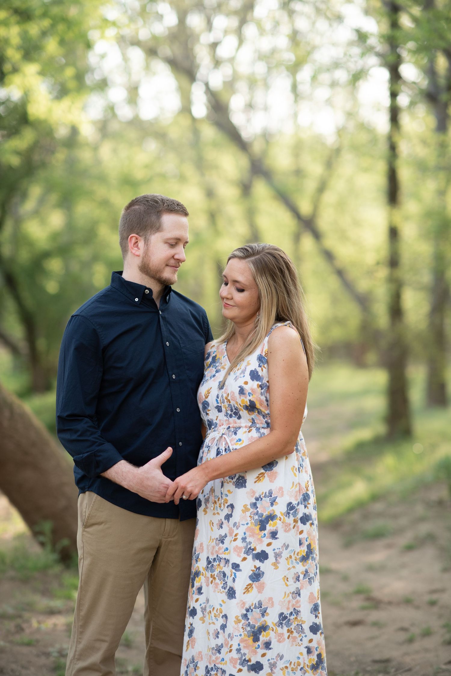 A couple in a wooded area embracing