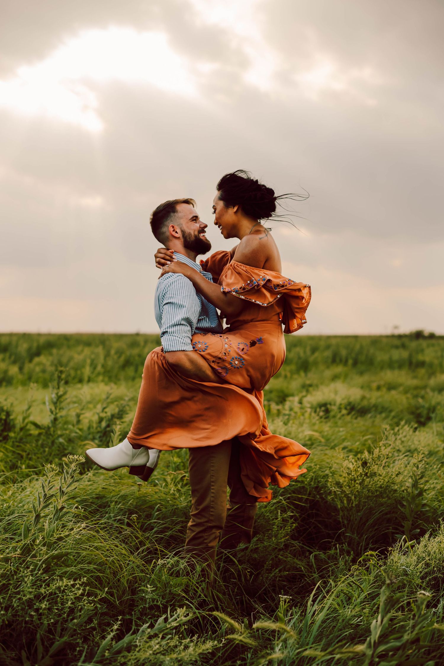 a man and woman spinning in a field