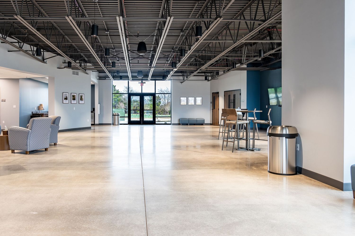 Large empty warehouse space with exposed ceiling and concrete floors.