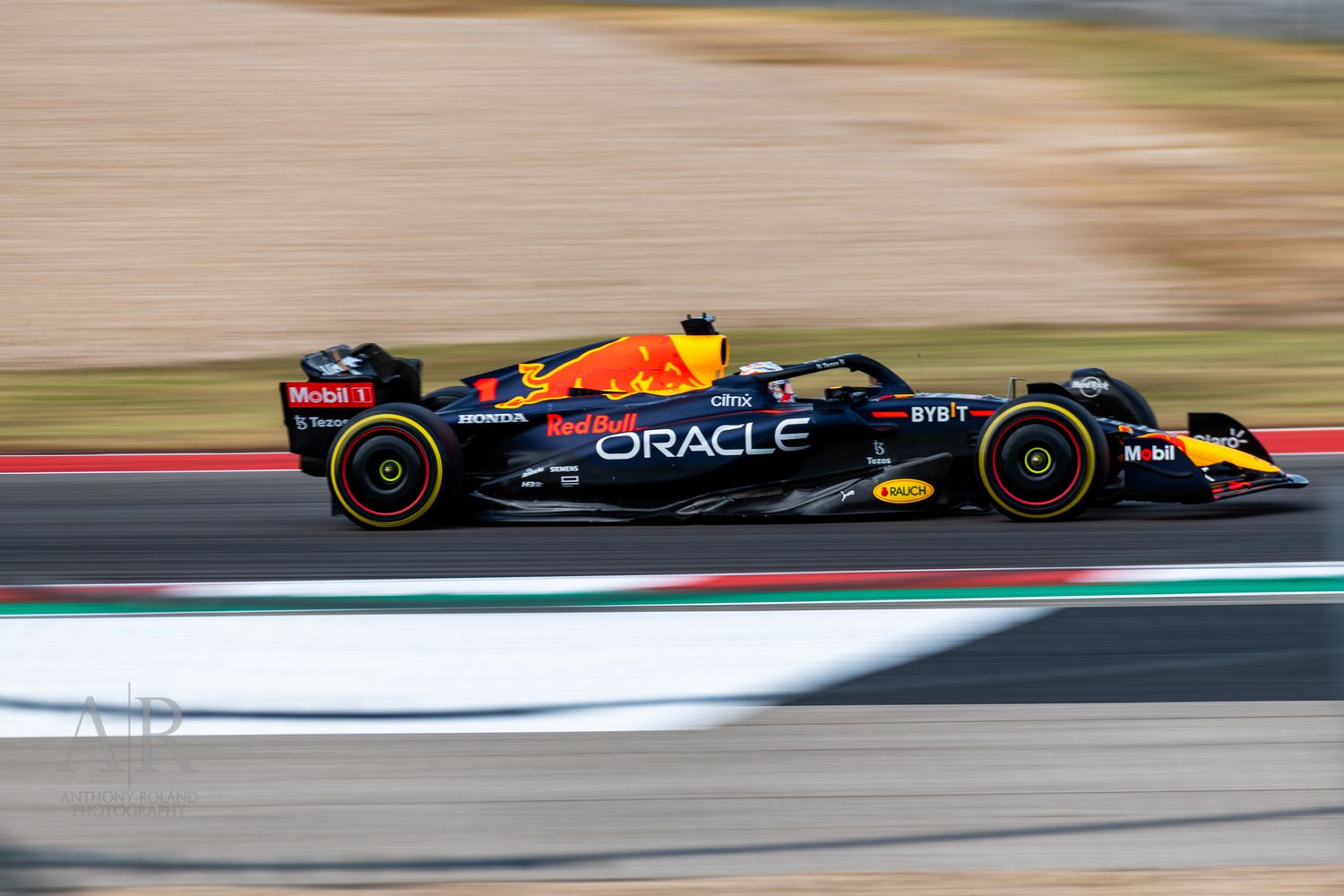 Formula 1 cars race at high speed through a circuit corner with Oracle Red Bull Racing visible.
