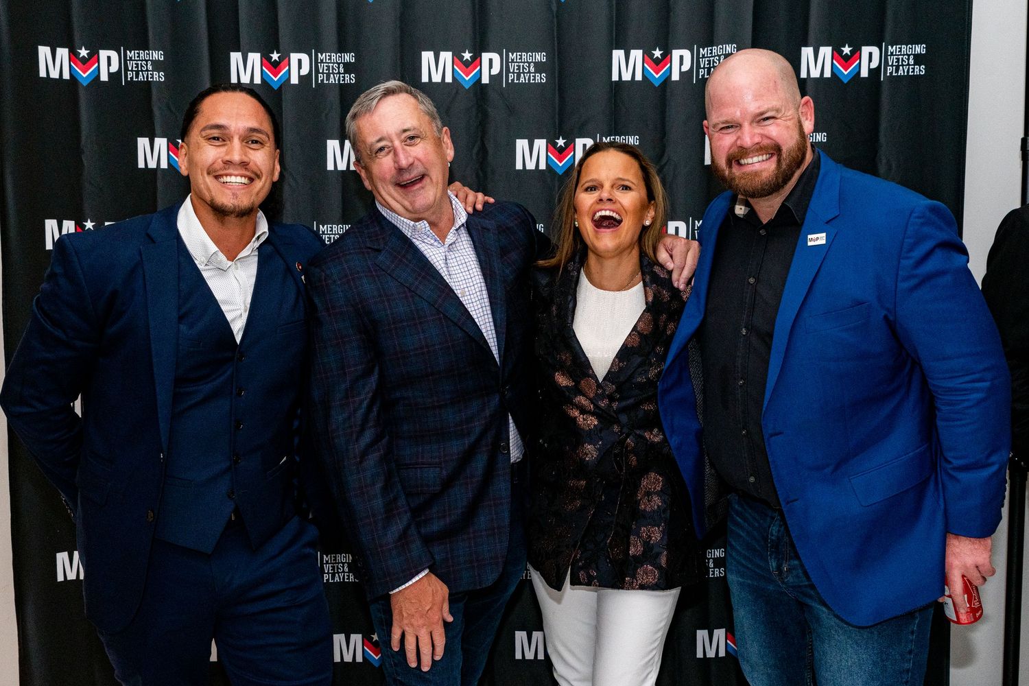 Professional group photo session against dark backdrop with MVPRE branding.