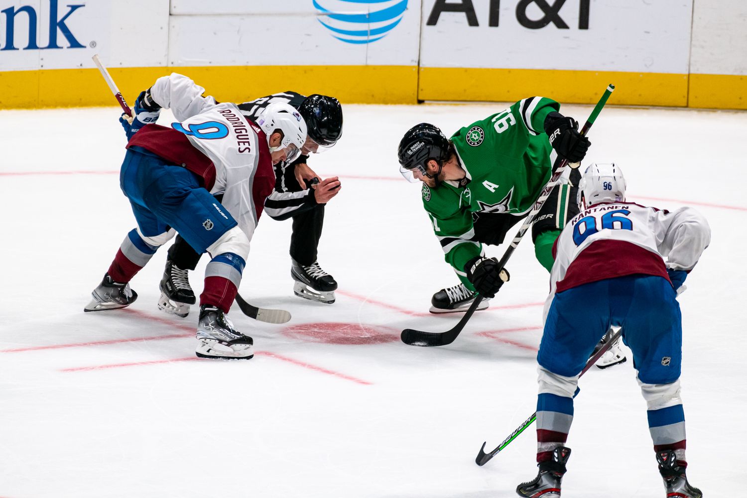 Hockey players from opposing teams face off during an intense game on the ice.