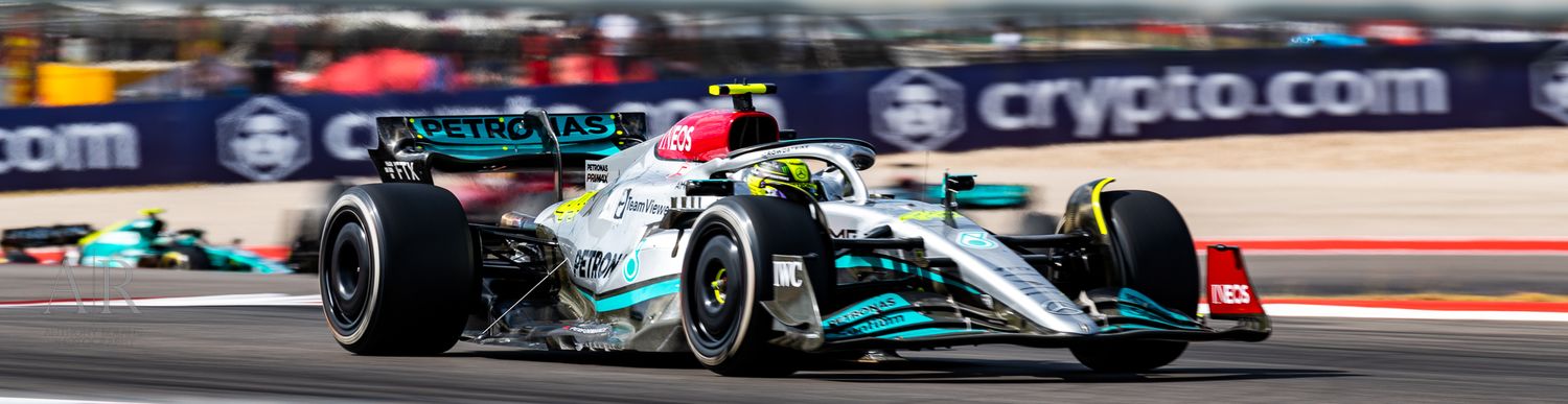 Formula 1 cars race on track with Crypto.com advertising visible in background.