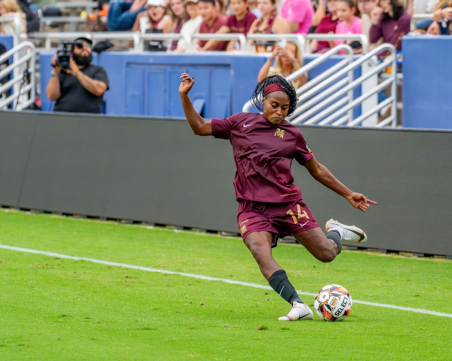 Soccer action sequence showing players in maroon uniforms making plays on the field.