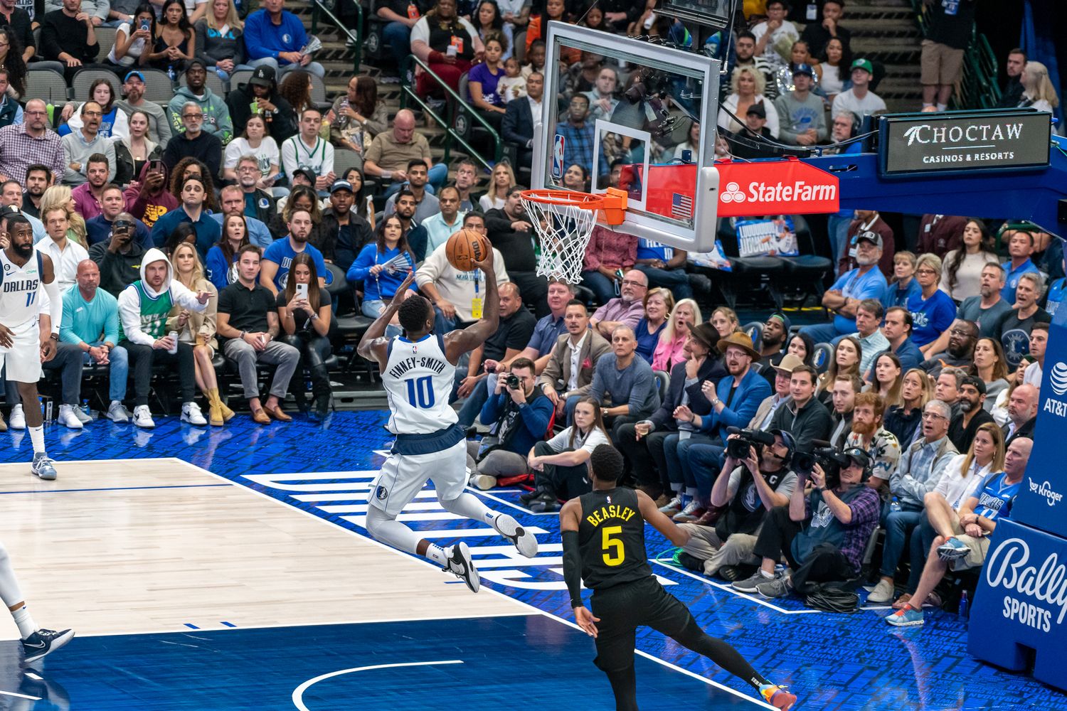 Wide view of basketball court during professional game with players in action.