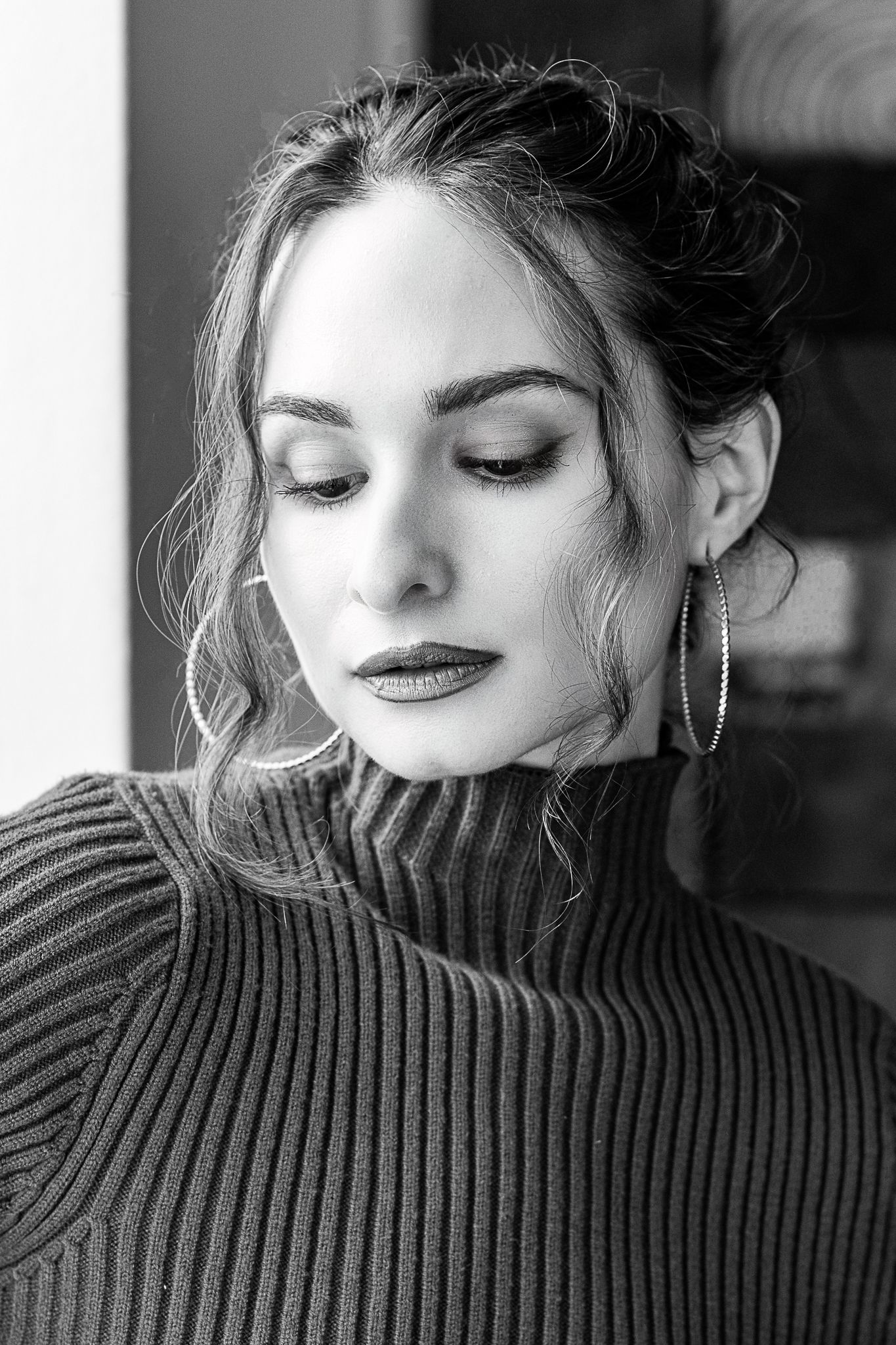 Black and white portrait series showing close-up details of a turtleneck sweater.