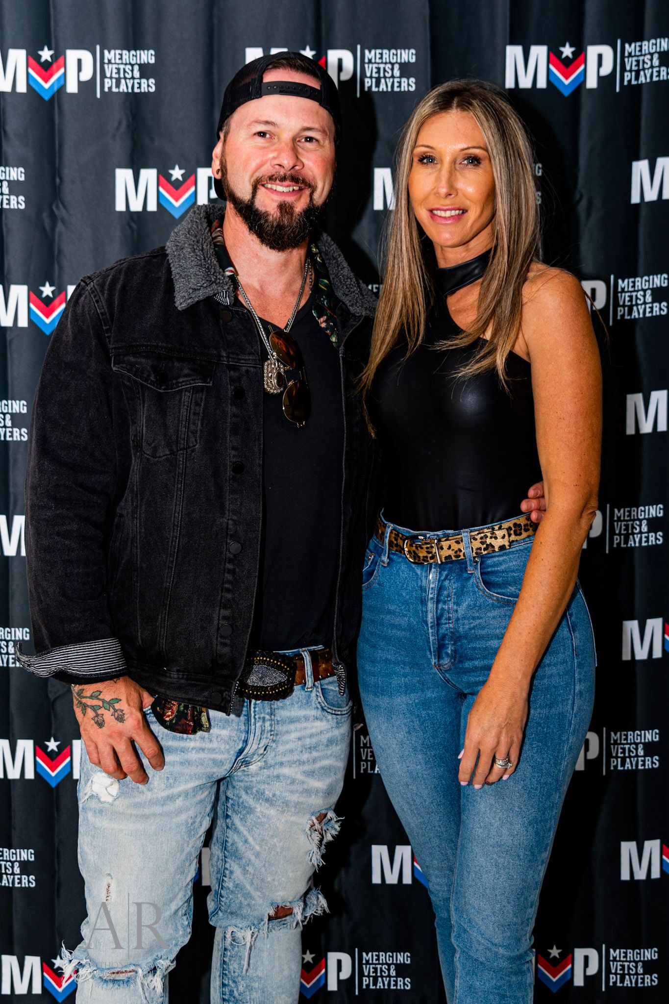 Event attendees posing against a branded backdrop with MOP logo.