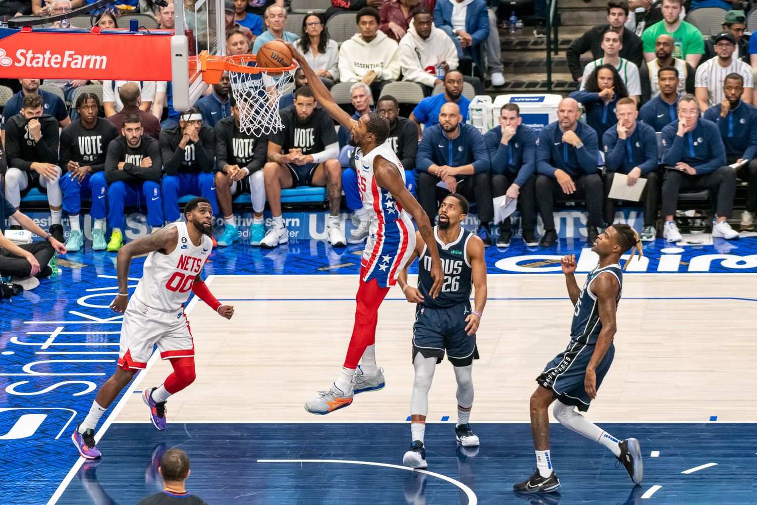 Players from opposing teams battle for position during an NBA basketball game.