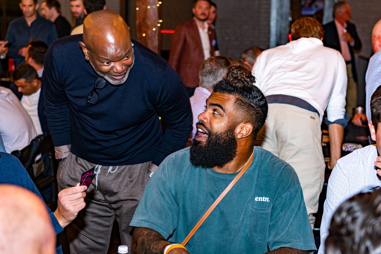 Casual gathering of people socializing at an indoor event space.