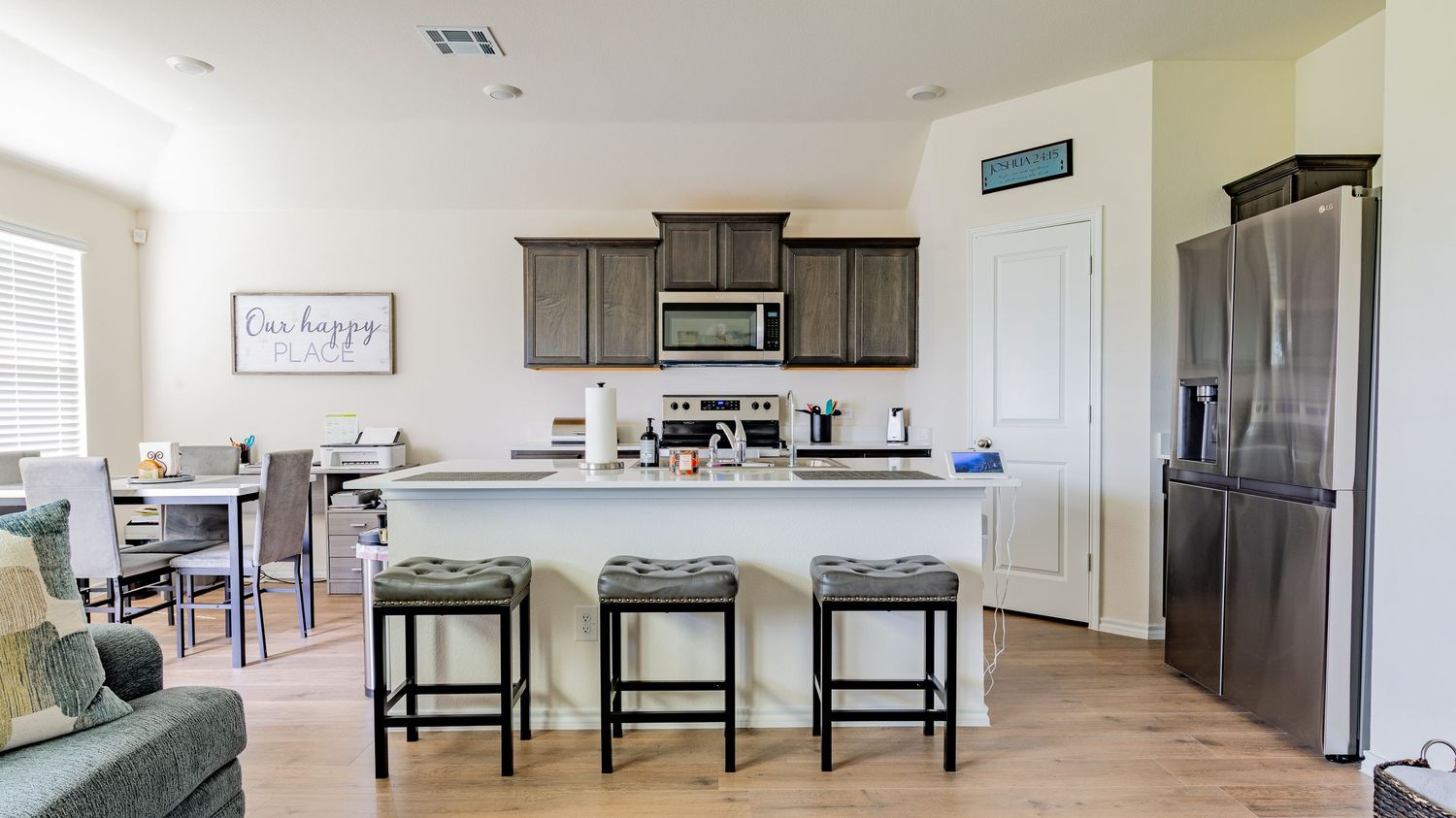 Open concept living space with modern furniture and neutral color scheme.