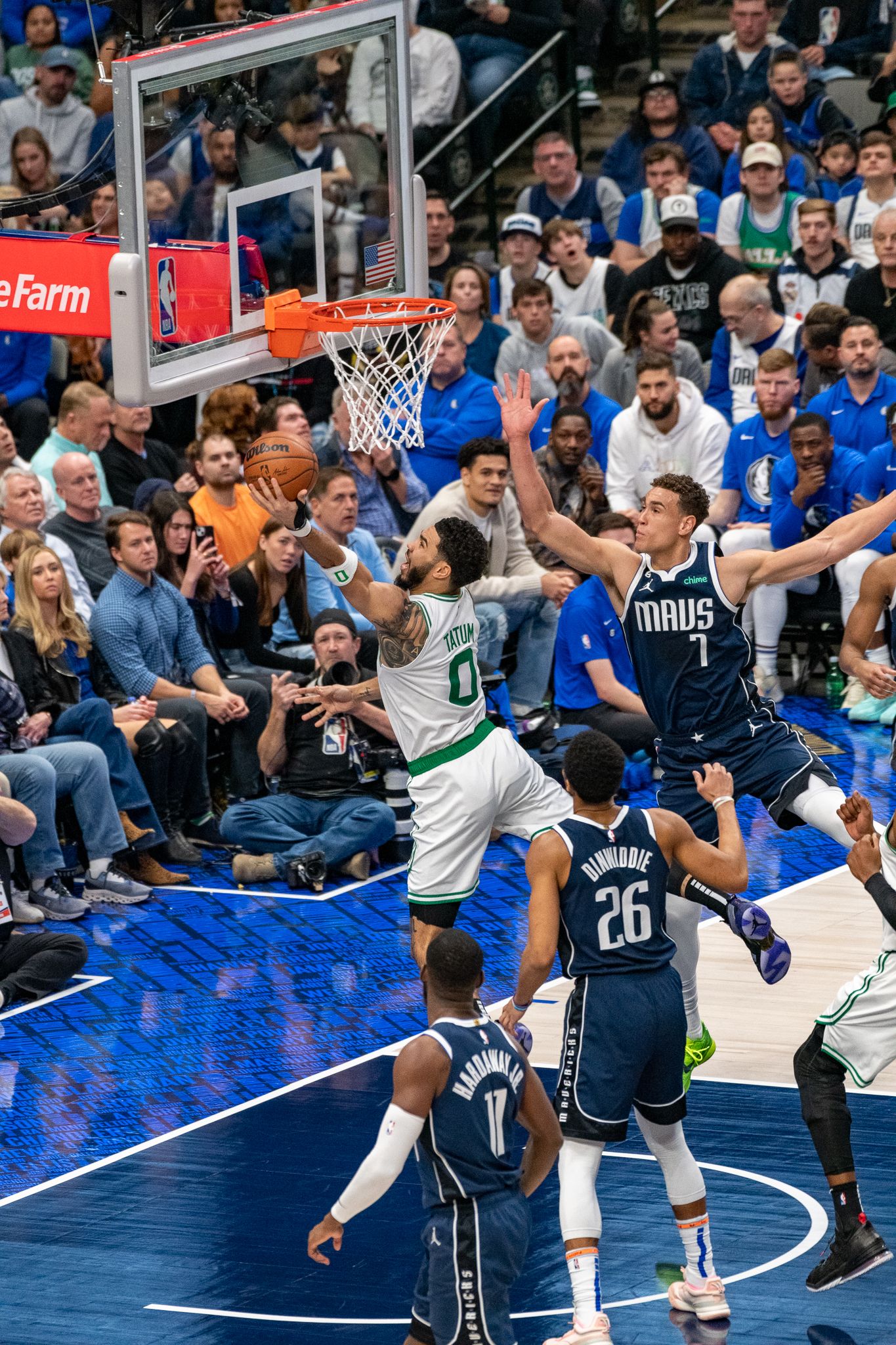 Basketball players competing for a rebound during an NBA game.
