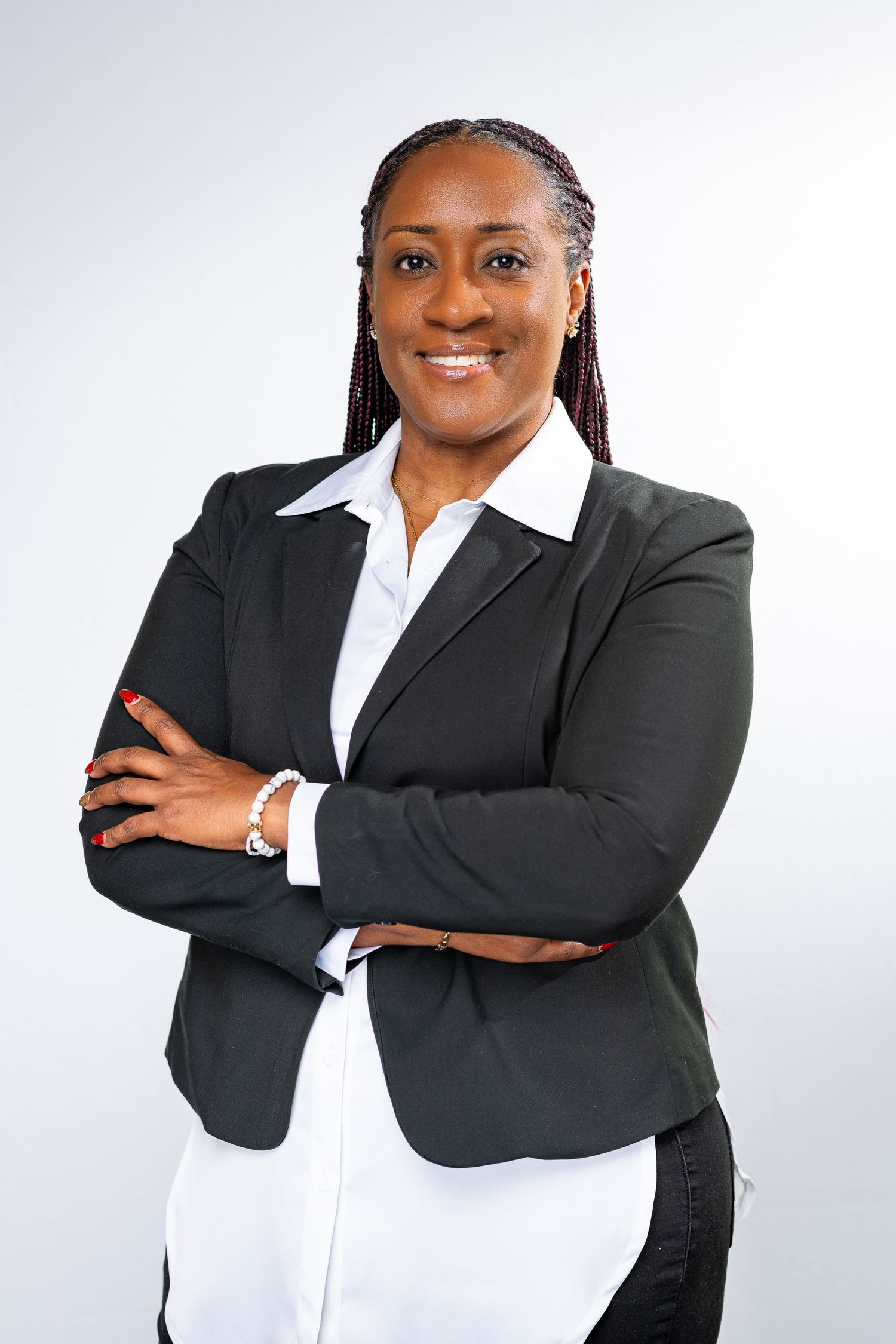 Professional headshots showing person in black blazer and white shirt against white background.