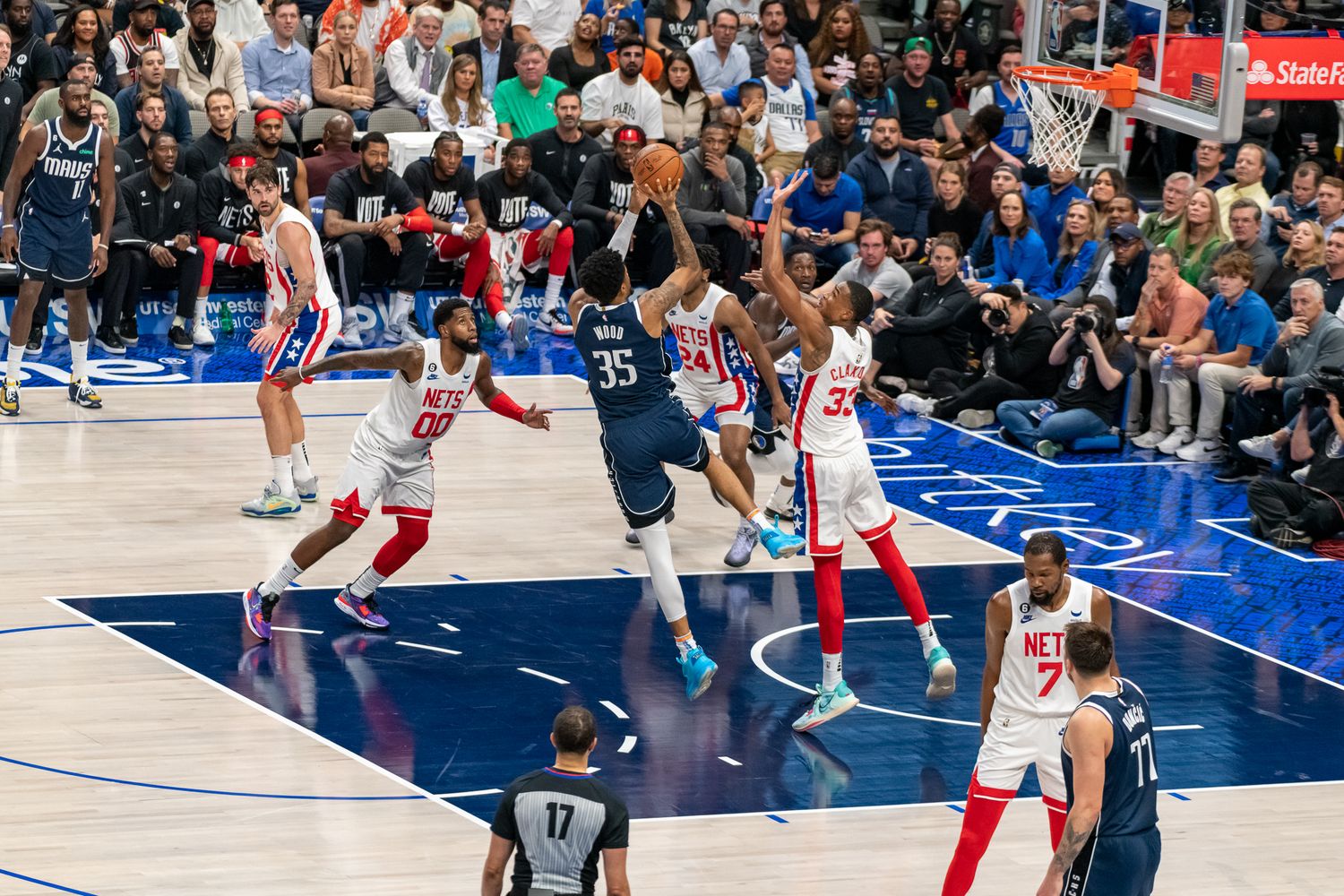 Professional basketball game in progress with players spread across the court during live action.