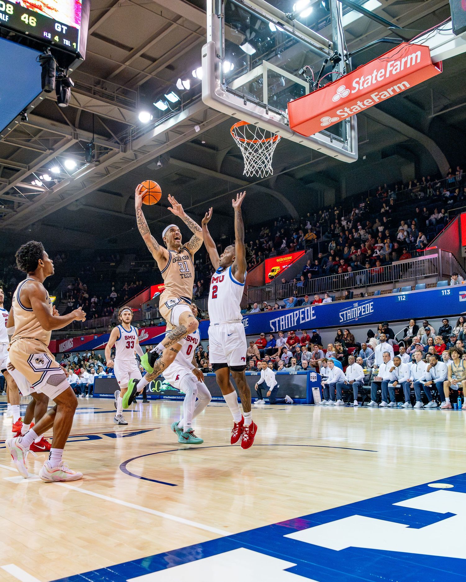 Basketball players compete for possession during a fast-paced game on a professional court.