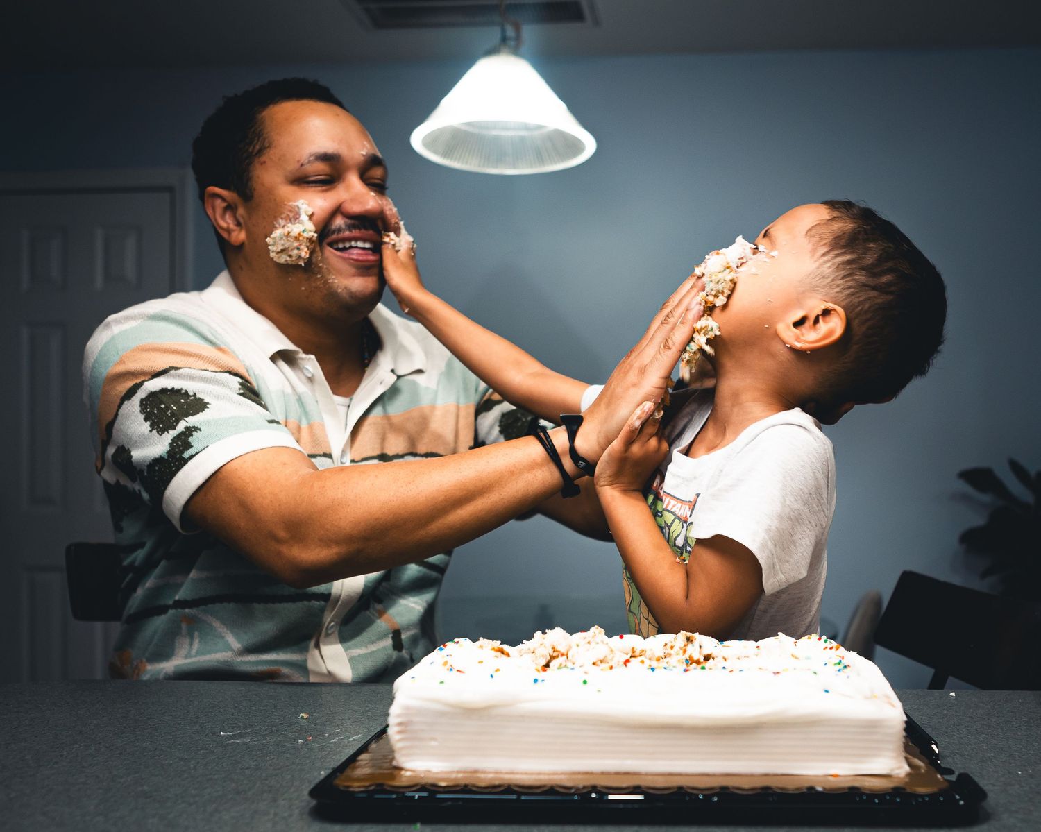 Savannah portrait photographer David Monroe —Series of joyful moments captured while playing with cake and frosting at a table.