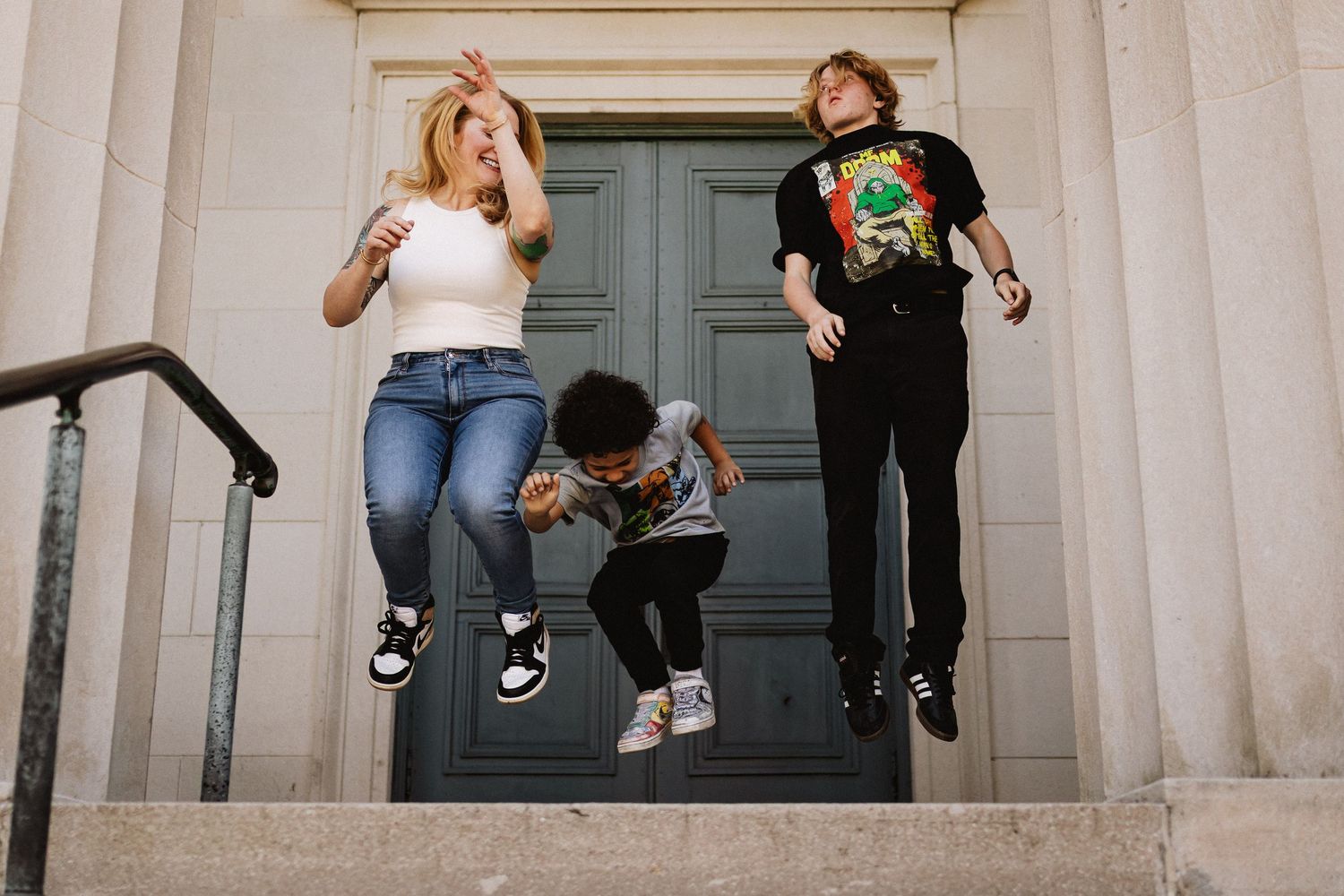 Savannah portrait photographer David Monroe —People sitting and posing casually on stone steps of a classic building with columns.