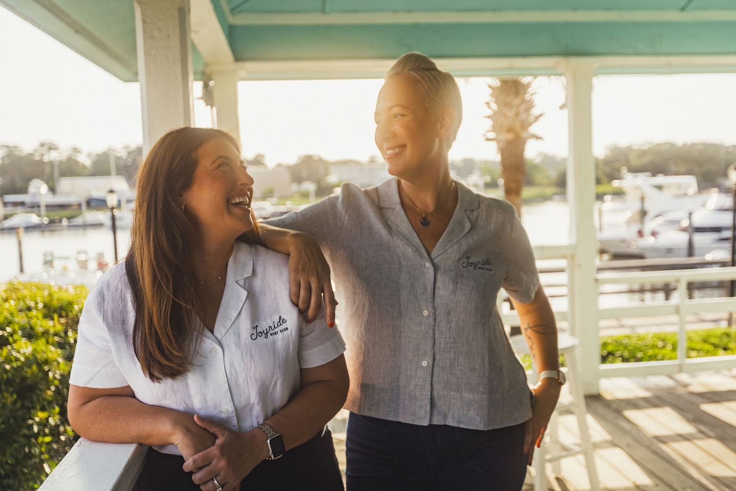 Savannah portrait photographer David Monroe —People laughing together on a coastal patio during golden hour.