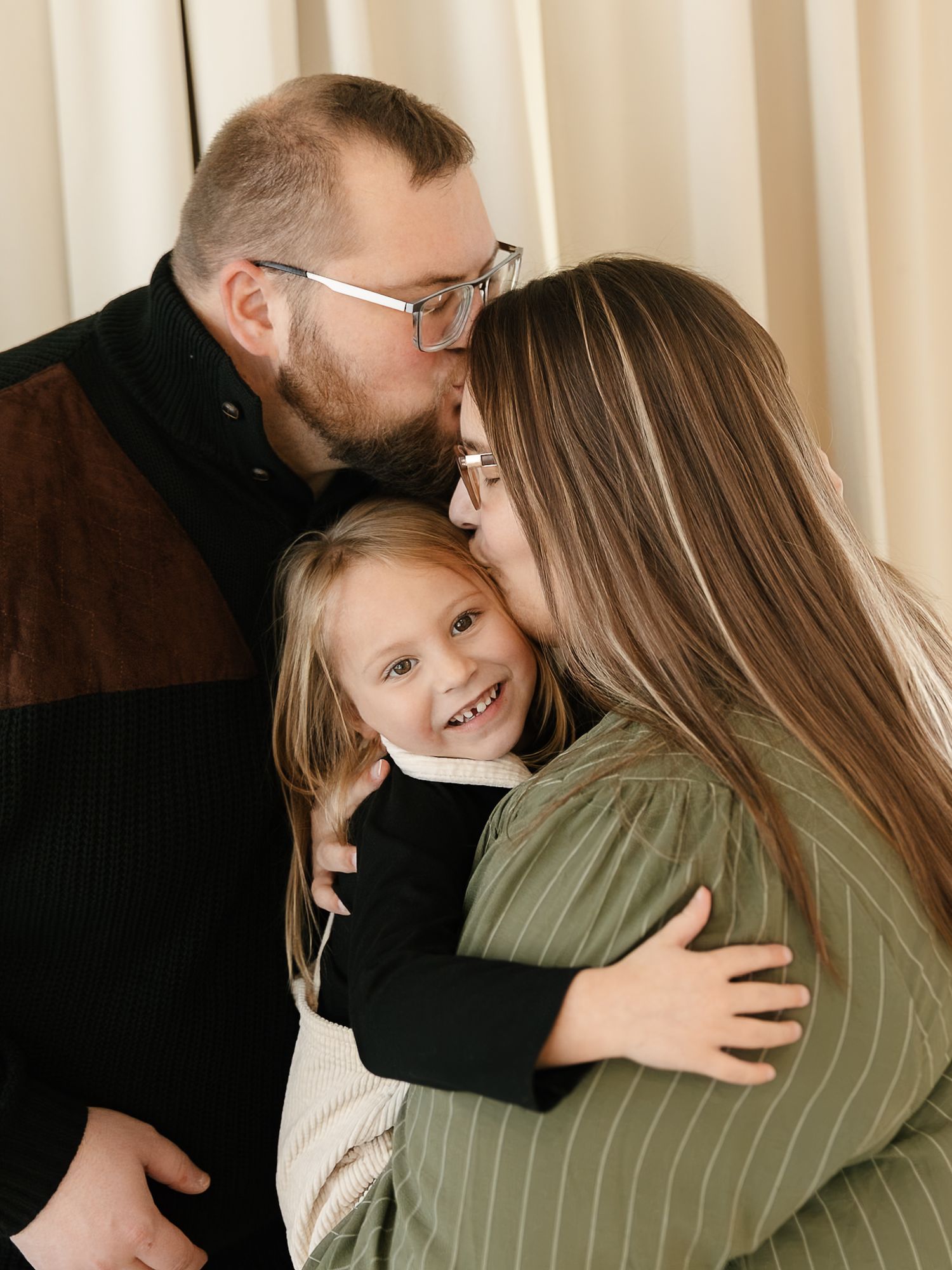A series of candid photos showing tender embraces and emotional moments between family members indoor studio, elkton SD