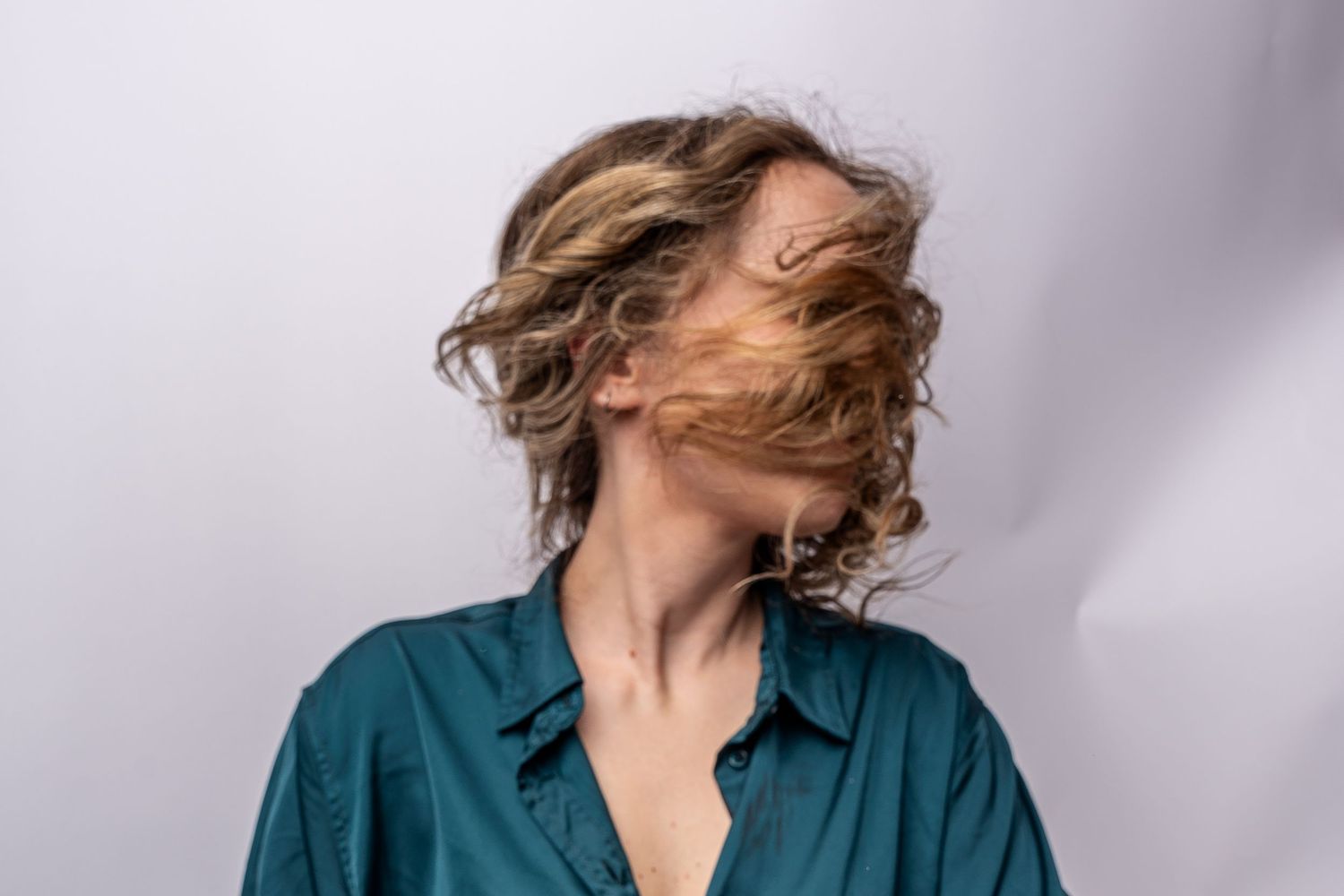 Portrait series showing dynamic hair movement against white backdrop. Regina, Saskatchewan portrait Photographer.