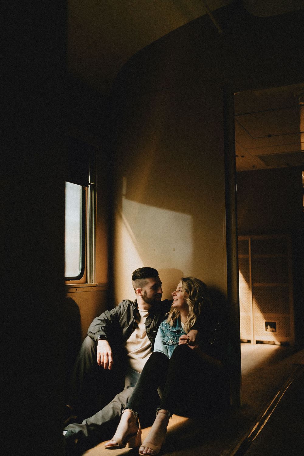 Artistic sequence in dark room showing silhouettes by window creating moody atmospheric lighting effect.