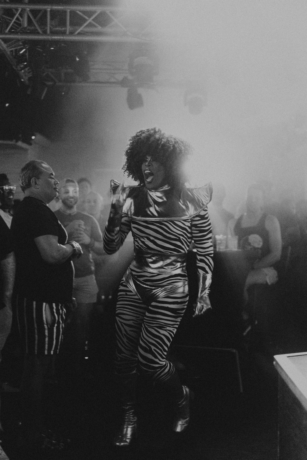 Black and white photo of people dancing at a crowded nightclub.
