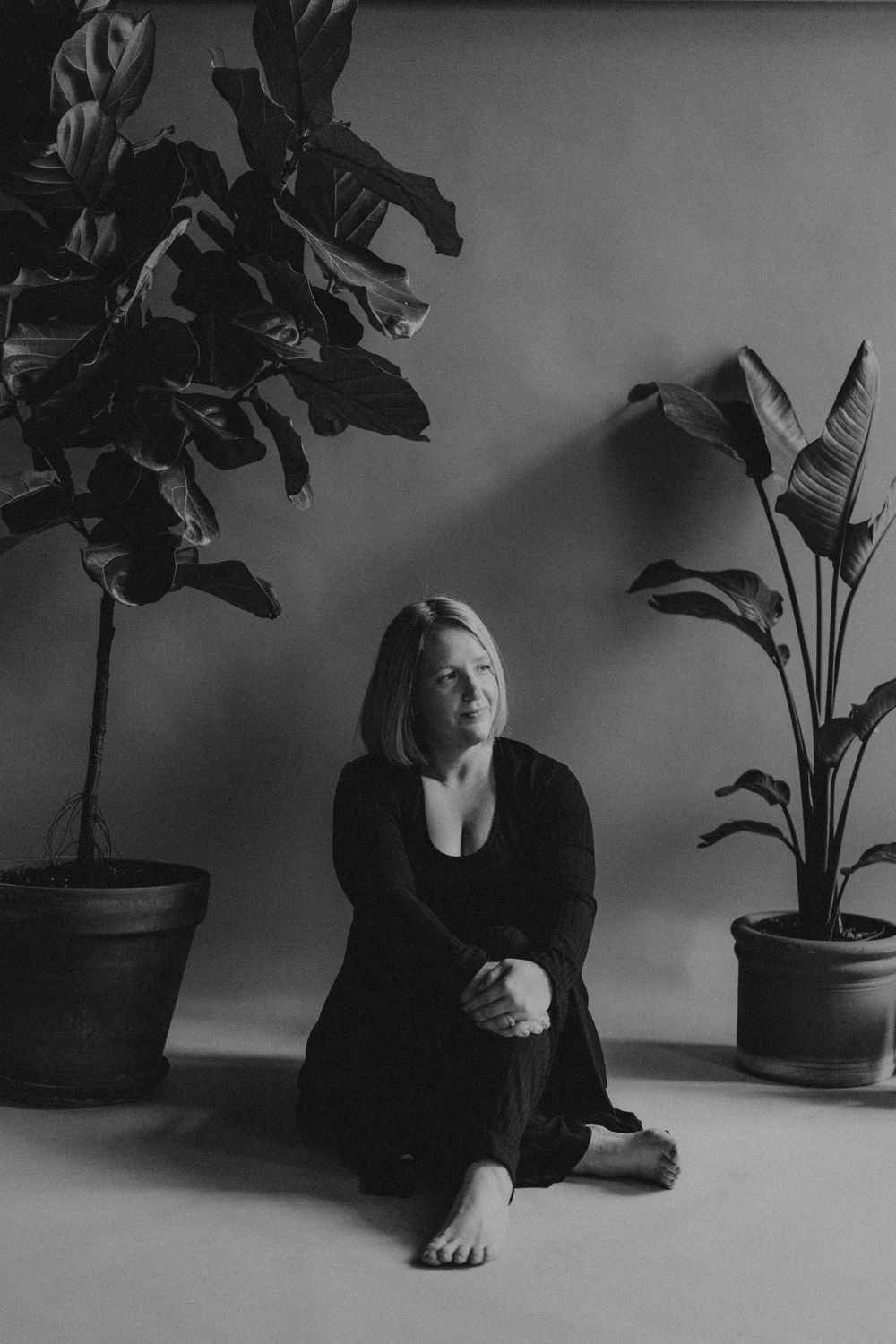 Artistic black and white photo sequence showing person in dark clothing reclining near potted plant.
