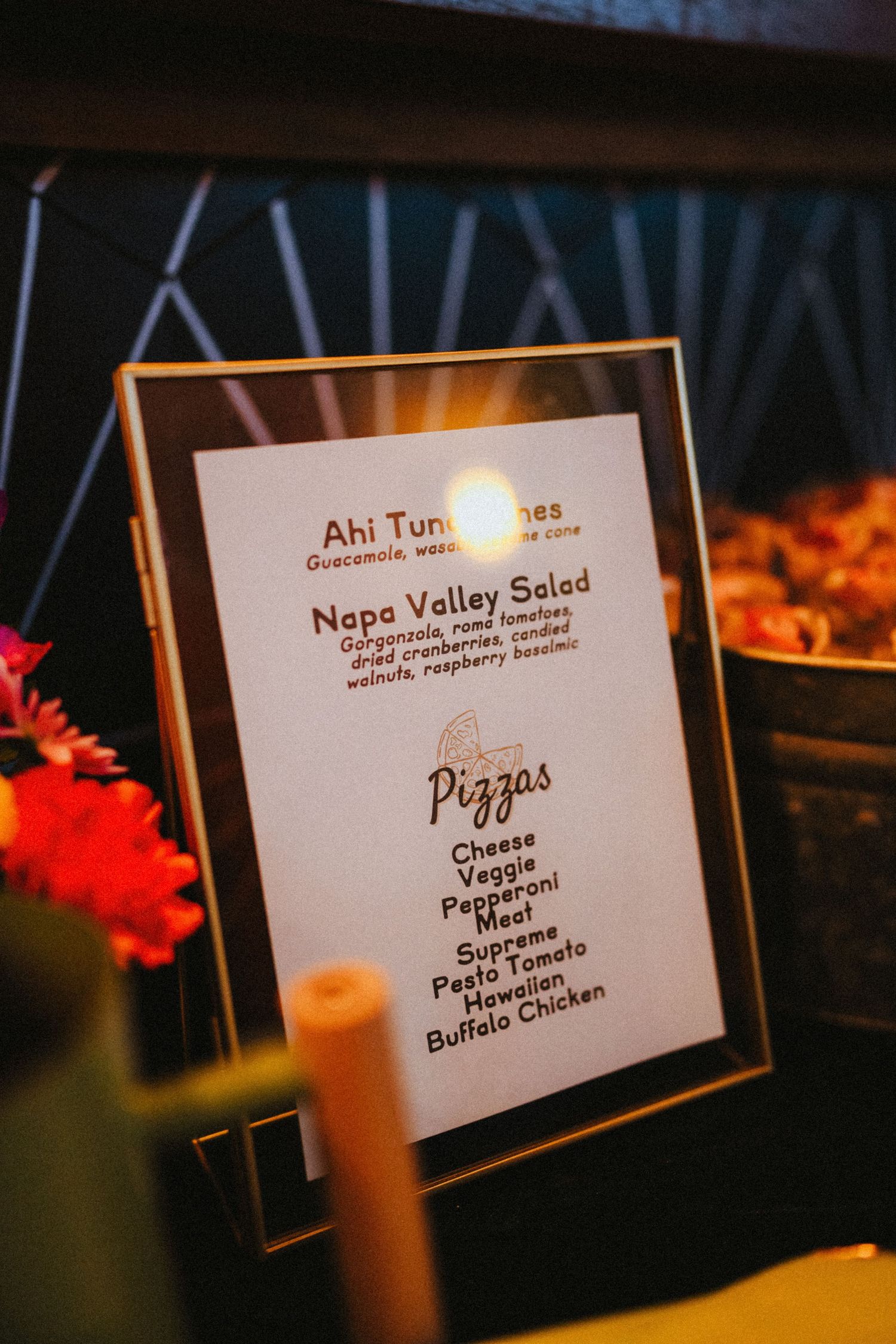 Framed wedding reception menu featuring ahi tuna, Napa Valley salad, and pizza options at event.