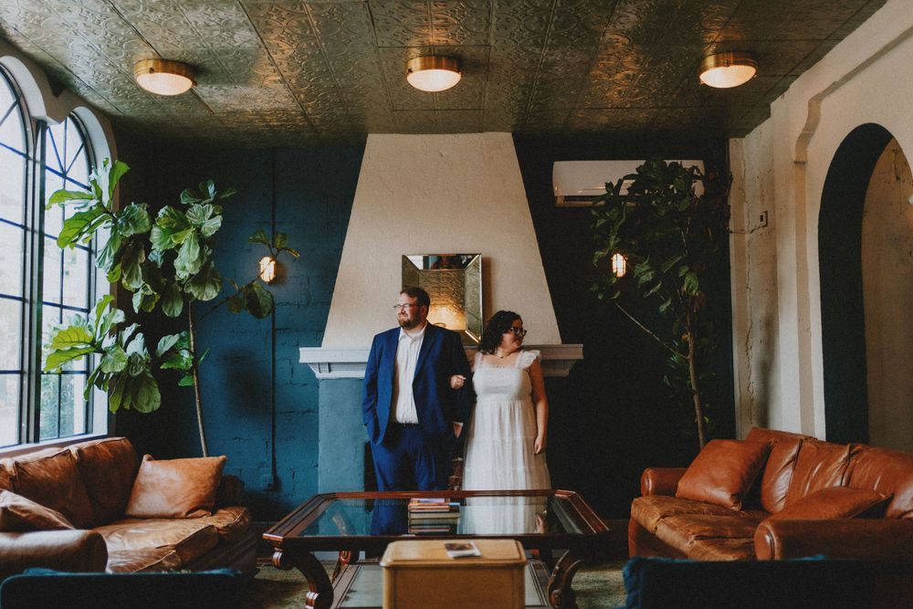 Interior of a stylish venue with leather seating and hanging plants.