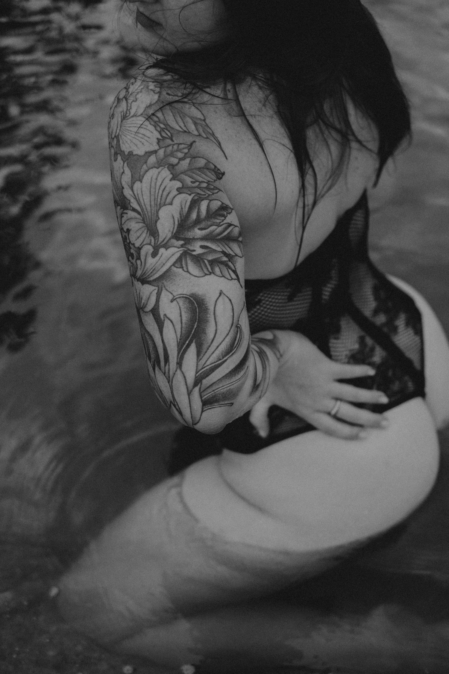 Artistic black and white photo showing intricate floral tattoo designs.
