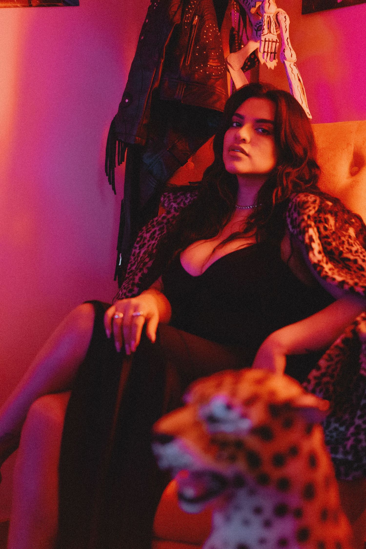 Moody portrait in red and purple lighting creating a dramatic atmospheric effect.
