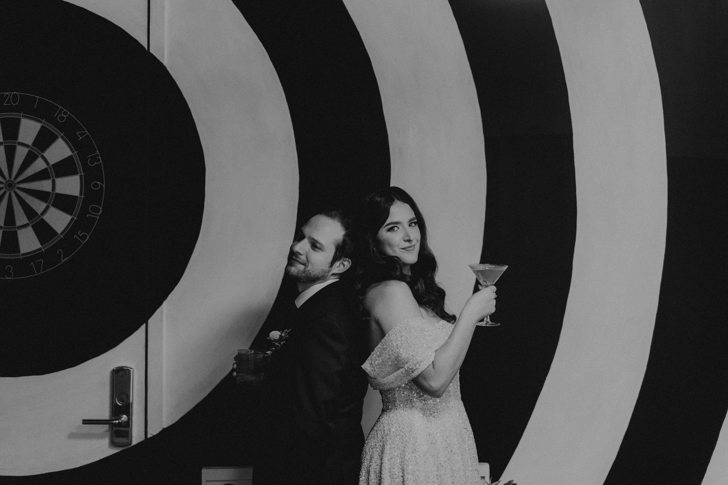 Modern event space with black and white spiral patterned wall design.