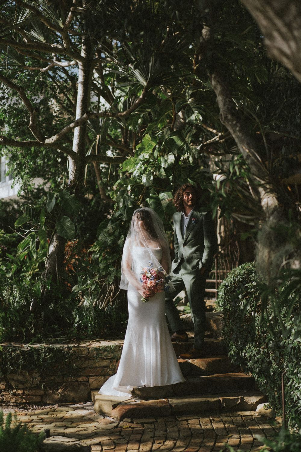 Wedding photography session among trees in a natural outdoor setting.
