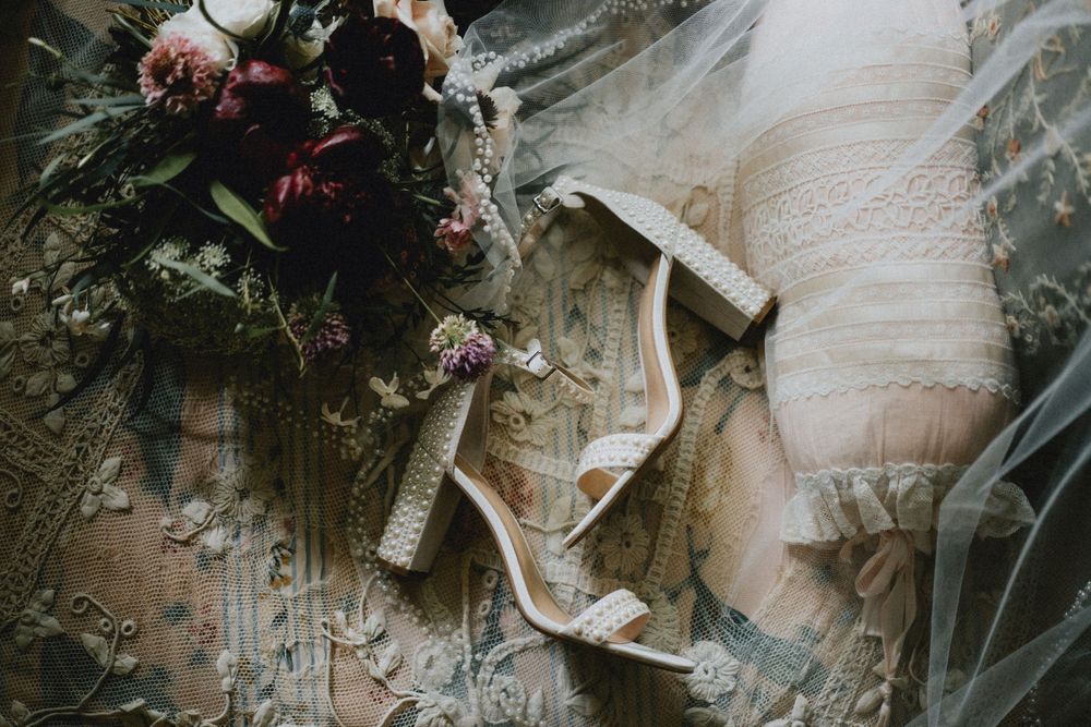Close-up detail of wedding dress fabric with delicate lace patterns.