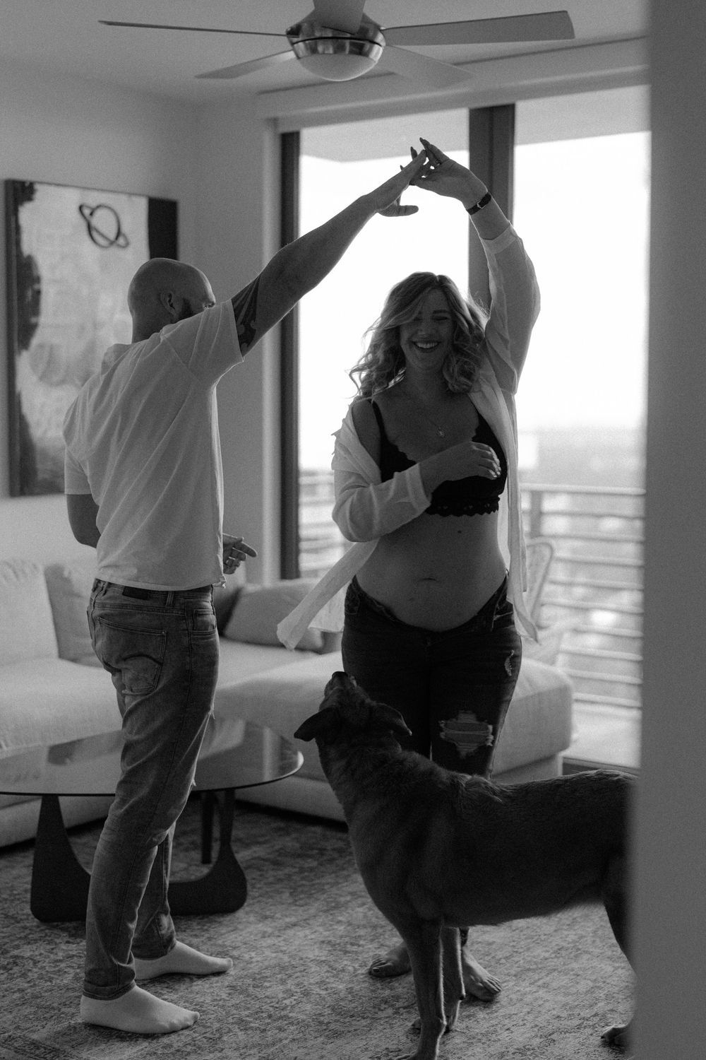 A series of black and white photos showing people dancing and moving together in an indoor space.