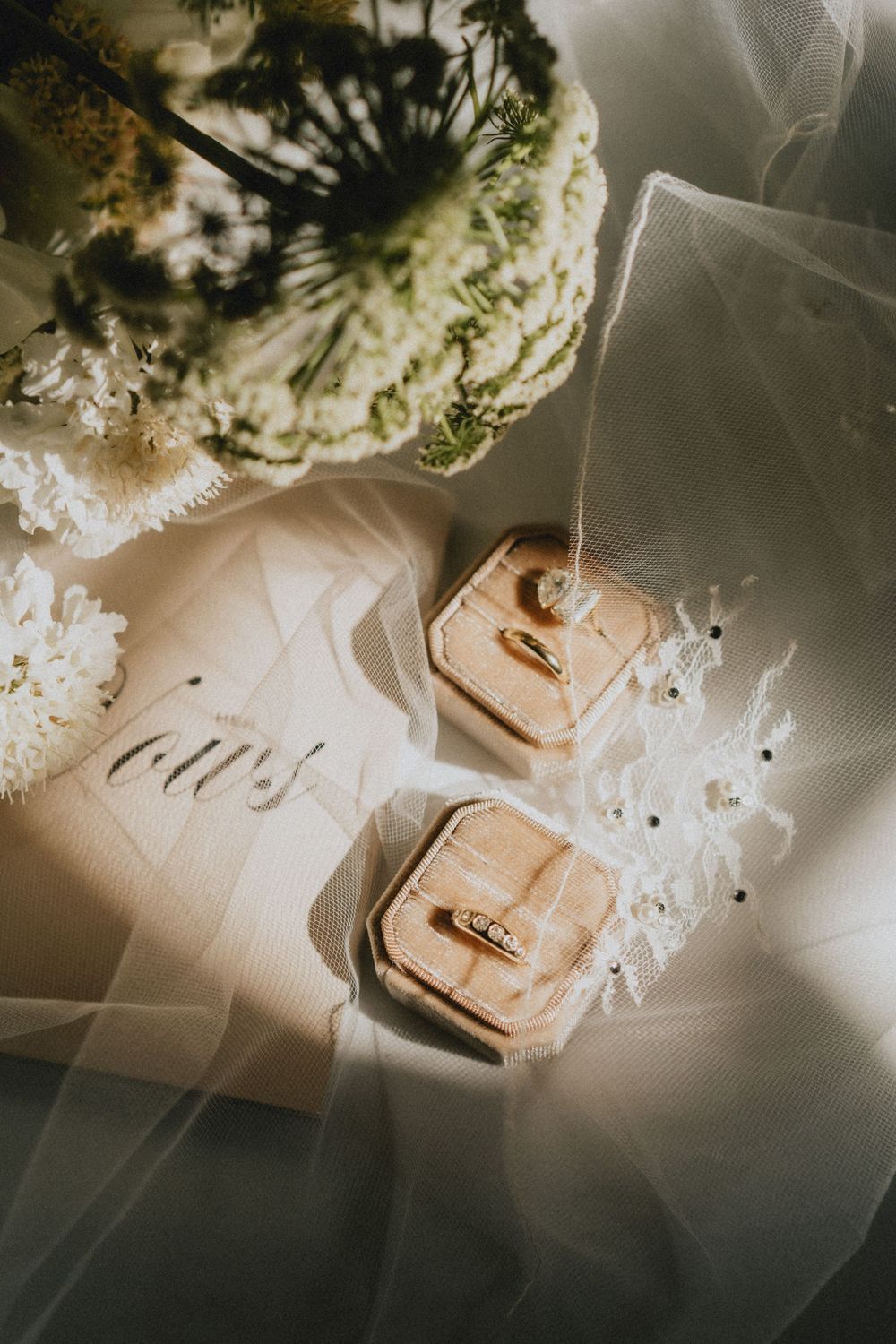 Wedding rings and calligraphy details captured in soft natural light.