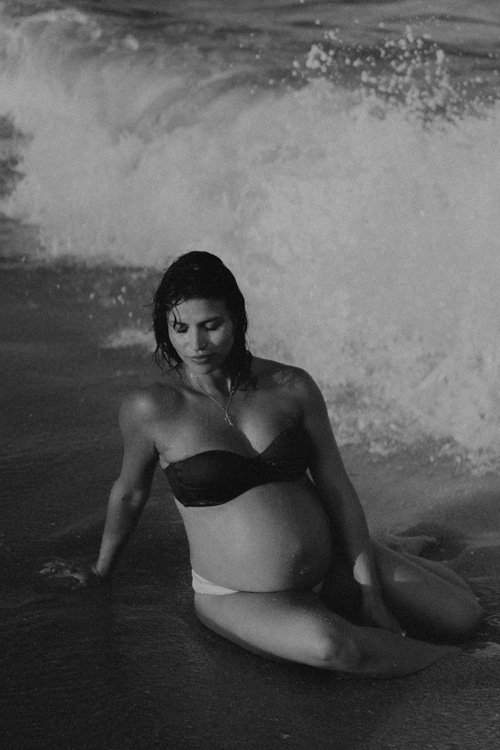 Black and white artistic photo sequence showing a swimmer gracefully moving through splashing waves.