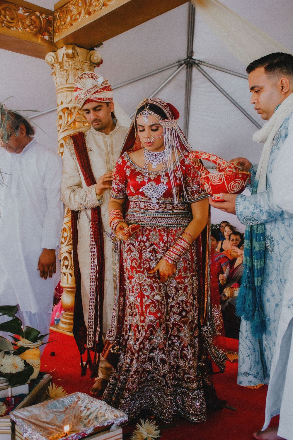 Traditional wedding ceremony with ornate red and gold cultural attire.