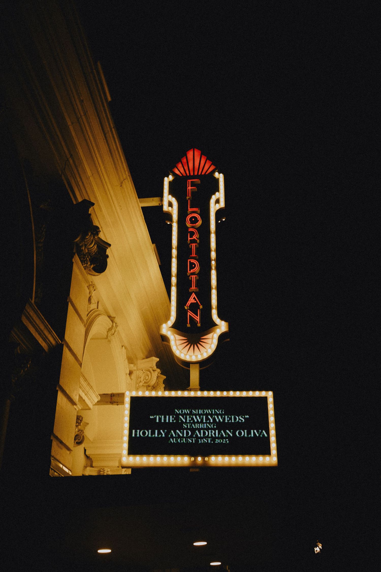 Floridian theater marquee sign glowing at night announcing newlyweds Holly and Adrian Oliva wedding celebration.