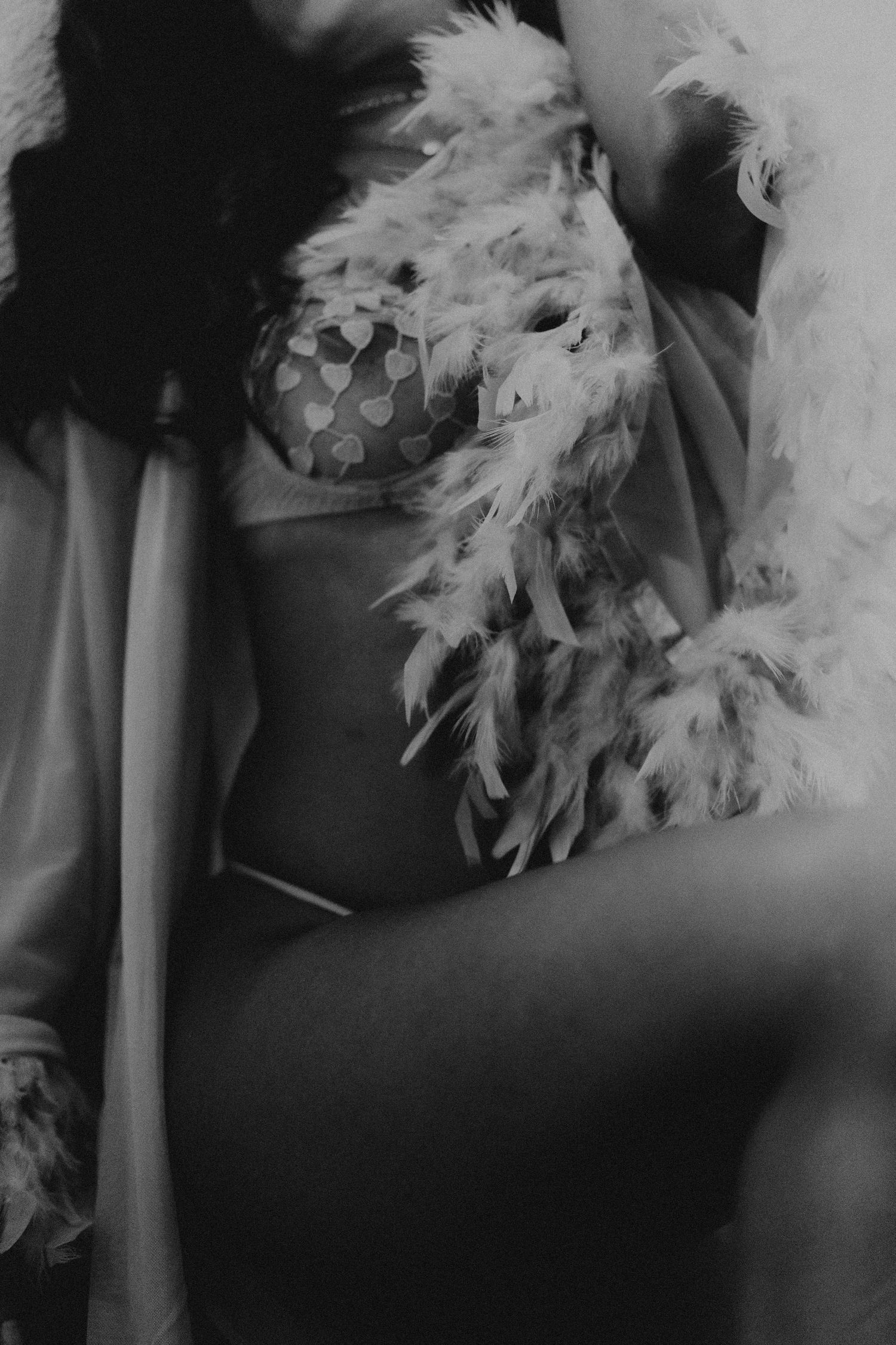 Black and white photo of feather accessories and intimate apparel.