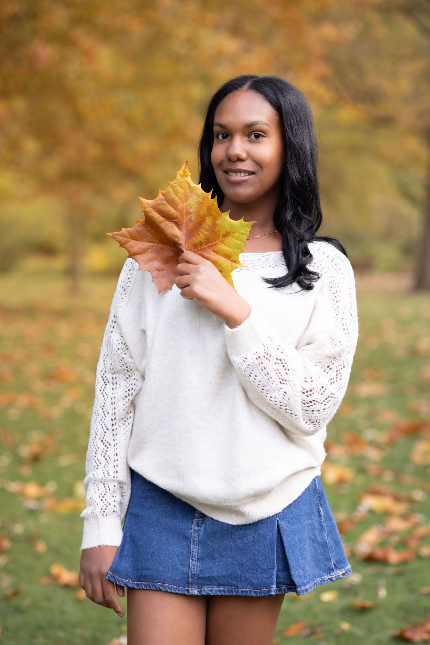 Teen girl holding maple leaf photography