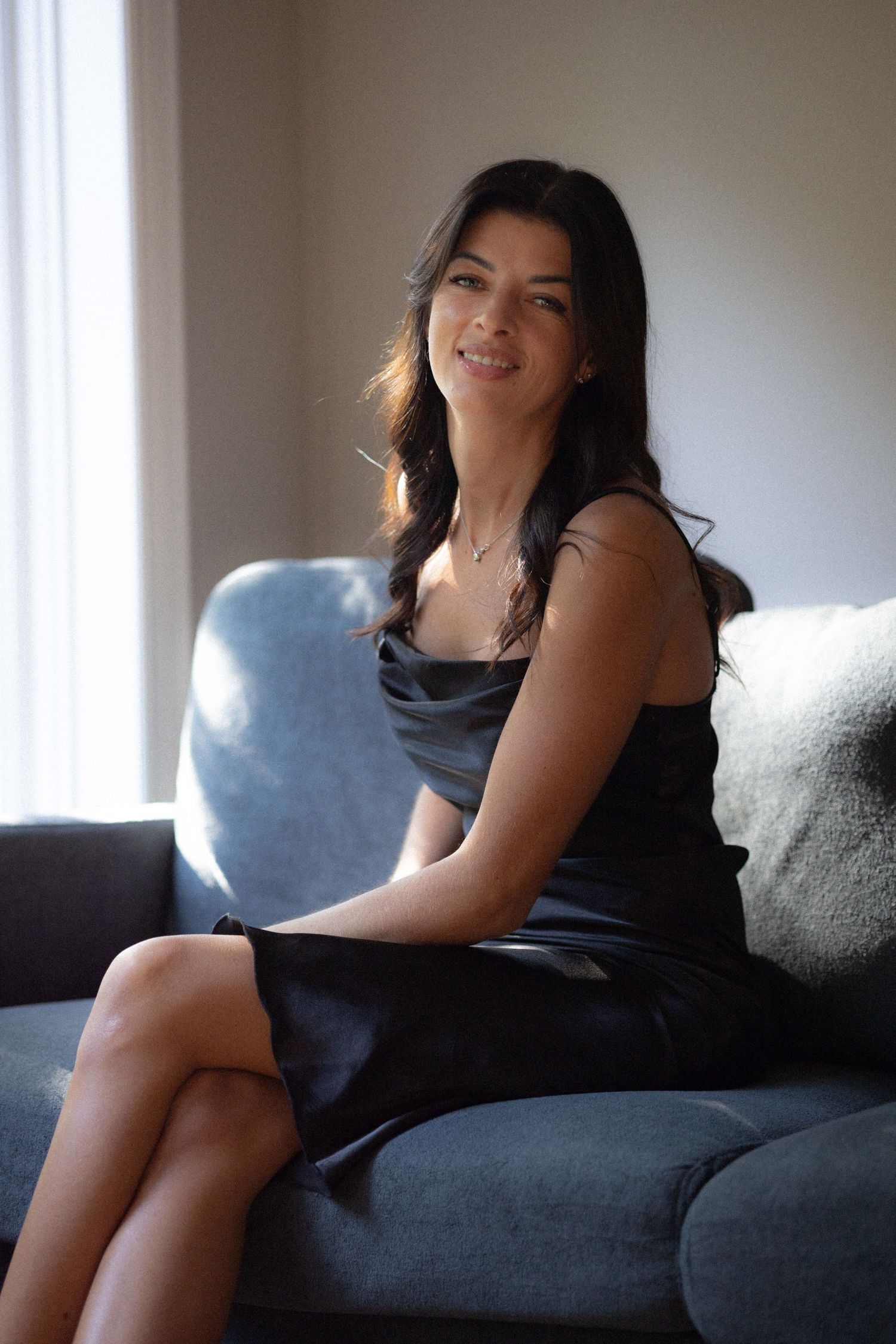 Woman in black dress sofa photography