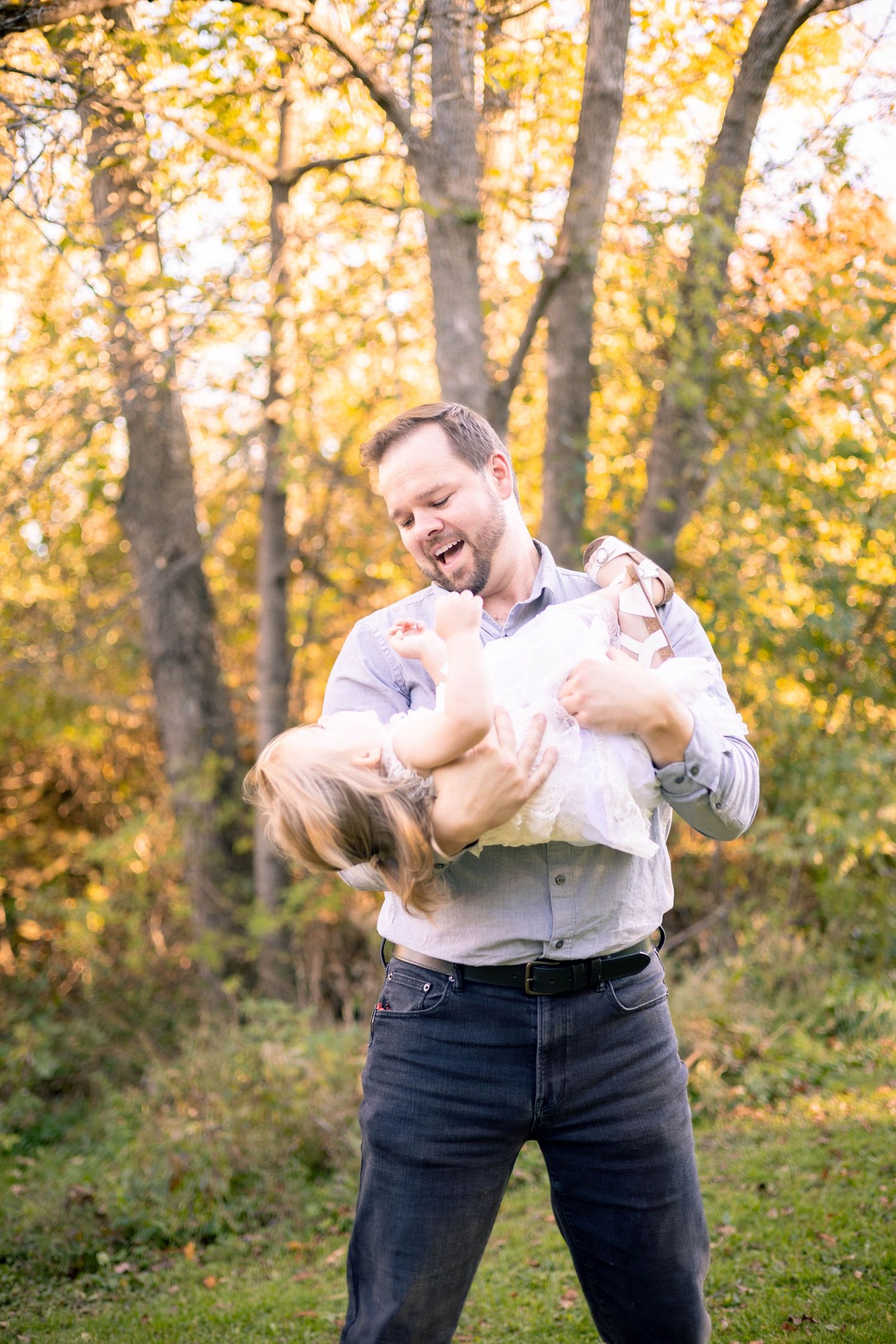 Father swinging baby girl autumn photography